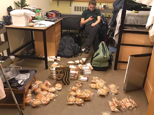 A student gathers donated food for redistribution