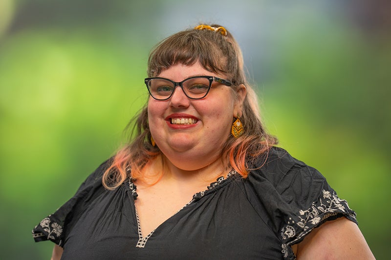 Woman with long blond hair smiles at the camera