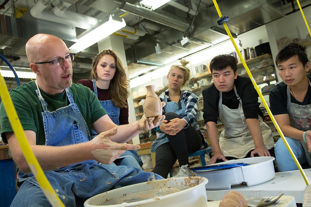 Instructor and Students working on pottery in the Craft Center