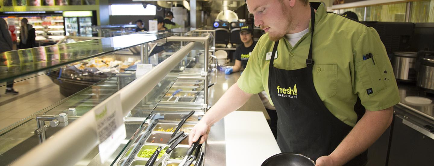 Student Dining working serving rice bowl.