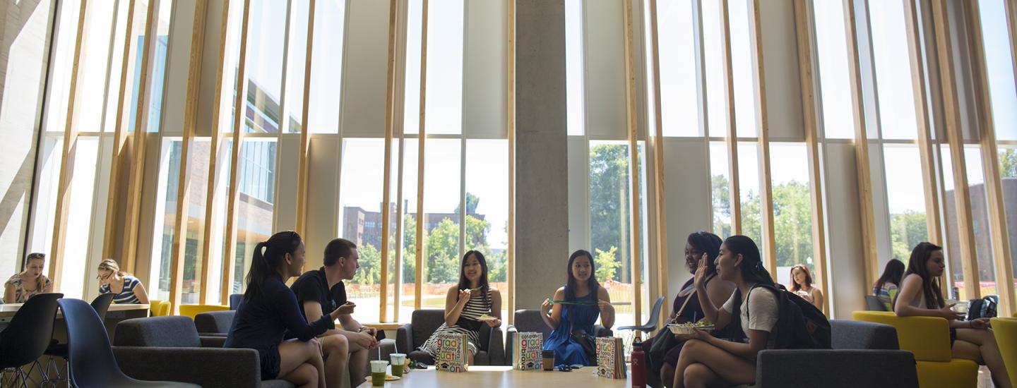 Students eating and discussing in EMU lounge.